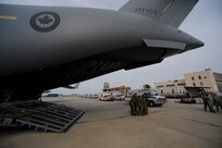 Emergency vehicles carrying evacuees of Hurricane Gustav stage near a Canadian Air Force C-17 at Lake Front Airport, New Orleans, La., Aug. 31, 2008. The Federal Emergency Management Agency and The Department of Defense chartered flights to transport citizens to destinations safely outside the hurricanes path. The Canadian Forces aircraft was brought in to help as part of the Civil Assistance Plan between the United States and Canada. 
