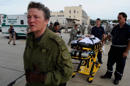 Canadian Air Force medical technician Kate Ryan helps evacuees of Hurricane Gustav to board a flight The U.S. Federal Emergency Management Agency and The Department of Defense chartered to transport citizens to destinations safely outside the hurricanes path Lake Front Airport, New Orleans, La., Aug. 31, 2008. The Canadian Forces aircraft was brought in to help as part of the Civil Assistance Plan between the United States and Canada. 