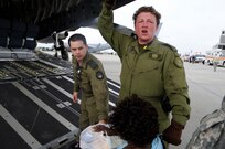 Canadian Air Force medical technician Kate Ryan helps evacuees of Hurricane Gustav to board a flight The U.S. Federal Emergency Management Agency and The Department of Defense chartered to transport citizens to destinations safely outside the hurricanes path Lake Front Airport, New Orleans, La., Aug. 31, 2008. The Canadian Forces aircraft was brought in to help as part of the Civil Assistance Plan between the United States and Canada. 