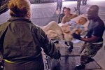 Air Force Maj. Janice McFall directs Airmen from the 50th Airlift Squadron, 463rd Airlift Group out of Little Rock Air Force Base, Ark., as they carry a hospital patient into a C-130 Hercules aircraft in Corpus Christi, Texas, Sept. 11, 2008, during a planned evacuation from Hurricane Ike. U.S. Northern Command is supporting federal, state and local Hurricane Ike response efforts in Texas, and aeromedical evacuation capabilities remain on alert pending FEMA requests for assistance. 