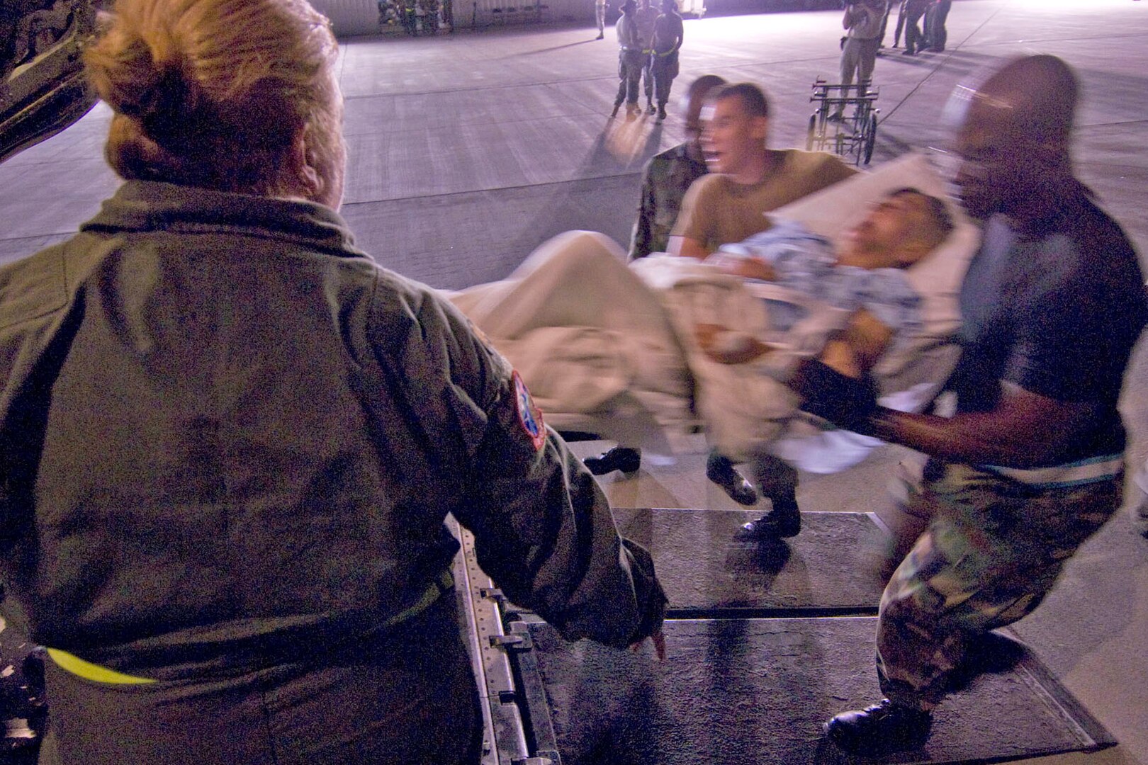 Air Force Maj. Janice McFall directs Airmen from the 50th Airlift Squadron, 463rd Airlift Group out of Little Rock Air Force Base, Ark., as they carry a hospital patient into a C-130 Hercules aircraft in Corpus Christi, Texas, Sept. 11, 2008, during a planned evacuation from Hurricane Ike. U.S. Northern Command is supporting federal, state and local Hurricane Ike response efforts in Texas, and aeromedical evacuation capabilities remain on alert pending FEMA requests for assistance. 