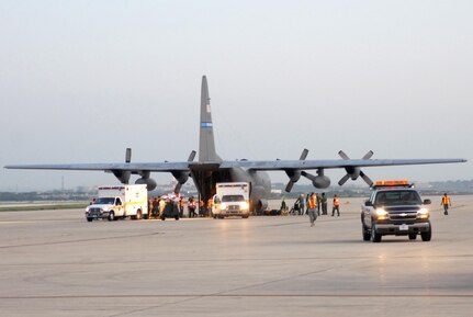 U.S. Air Force Airmen from the 37th and 59th Air Wing unload hospital patients at Lackland Air Force Base, Texas, Sept. 12, 2008, that were evacuated from Beaumont, Texas.  These patients were transported by a combined effort from the Little Rock Air Force Base C-130 aircraft and crews and the 908th Aero medical Evacuation Squadron, Scott Air Force Base, Ill., in preparation for Hurricane Ike's landfall in southern Texas.  