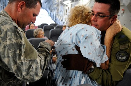 U.S. and Canadian Armed Forces personnel help an evacuee of Hurricane Gustav to board a flight. The U.S. Federal Emergency Management Agency and The Department of Defense chartered to transport citizens to destinations safely outside the hurricanes path Lake Front Airport, New Orleans, La., Aug. 31, 2008. The Canadian Forces aircraft was brought in to help as part of the Civil Assistance Plan between the United States and Canada.
