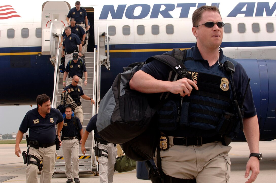 Members of the Federal Air Marshals exit an aircraft at the Louis Armstrong International Airport, New Orleans, Louisiana, after Hurricane Gustav made landfall, Sep. 3, 2008.  