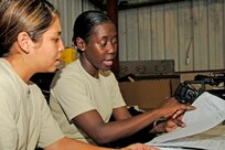 Staff Sgt Jennifer Corbin from MacDill Air Force Base, Fla., and Tech Sgt. Jameria Doyle from Dobbins Air Reserve Base, Ga., look over administrative paperwork before Hurricane Ike evacuees arrive in Corpus Christi, Texas. U.S. Northern Command is supporting federal, state and local hurricane response efforts in Texas. 