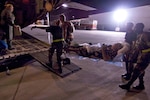 Military personnel take a medical patient to an Air Force C-130 cargo aircraft for evacuation Wednesday, Sept. 10, 2008, from Corpus Christi, Texas, to a medical facility in Dallas as Hurricane Ike approaches the Texas Gulf Coast. U.S. Northern Command is supporting federal, state and local Hurricane Ike response efforts in Texas, and aeromedical evacuation capabilities remain on alert pending FEMA requests for assistance.