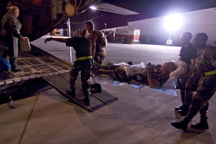 Military personnel take a medical patient to an Air Force C-130 cargo aircraft for evacuation Wednesday, Sept. 10, 2008, from Corpus Christi, Texas, to a medical facility in Dallas as Hurricane Ike approaches the Texas Gulf Coast. U.S. Northern Command is supporting federal, state and local Hurricane Ike response efforts in Texas, and aeromedical evacuation capabilities remain on alert pending FEMA requests for assistance.