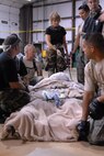 U.S. Air Force Airmen made up of active duty, Guard, and Reserve from multiple Air Force bases load hospital patients onto a C-130 aircraft at Beaumont Airport in Texas Sept. 12, 2008. Little Rock Air Force Base C-130s were deployed to perform aero medical and transportation missions in preparation for Hurricane Ike's landfall in southern Texas.  