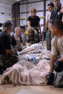 U.S. Air Force Airmen made up of active duty, Guard, and Reserve from multiple Air Force bases load hospital patients onto a C-130 aircraft at Beaumont Airport in Texas Sept. 12, 2008. Little Rock Air Force Base C-130s were deployed to perform aero medical and transportation missions in preparation for Hurricane Ike's landfall in southern Texas.  