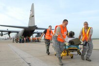 U.S. Air Force Airmen from the 37th and 59th Air Wing unload hospital patients at Lackland Air Force Base, Texas, Sept. 12, 2008, that were evacuated from Beaumont, Texas.  These patients were transported by a combined effort from the Little Rock Air Force Base C-130 aircraft and crews and the 908th Aero medical Evacuation Squadron, Scott Air Force Base, Ill., in preparation for Hurricane Ike's landfall in southern Texas.  