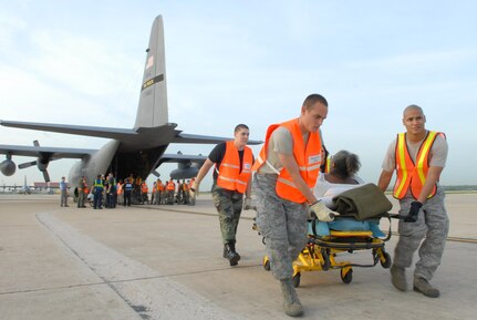 U.S. Air Force Airmen from the 37th and 59th Air Wing unload hospital patients at Lackland Air Force Base, Texas, Sept. 12, 2008, that were evacuated from Beaumont, Texas.  These patients were transported by a combined effort from the Little Rock Air Force Base C-130 aircraft and crews and the 908th Aero medical Evacuation Squadron, Scott Air Force Base, Ill., in preparation for Hurricane Ike's landfall in southern Texas.  