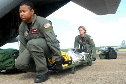 U.S. Air Force Tech. Sgt. Angela Burton and Senior Airman Melinda Ford unload medical equipment from a C-130 at Little Rock Air Force Base, Ark., Sept. 12, 2008.  The Airmen were part of a combined effort from the 61st Air Wing C-130 aircraft and crews from Little Rock Air Force Base and the 908th Aero medical Evacuation Squadron Scott Air Force Base, Ill., to transport medical patients from Beaumont, Texas, to Lackland AFB, Texas, in preparation for Hurricane Ike's landfall in southern Texas.  