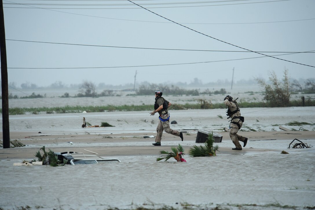 U.S. Air Force Senior Airman Brandon Smith (left)and Staff Sgt. Lopaka Mounts, both Pararescueman assigned to the 331st Air Expeditionary Group conduct search and rescue operations in Galveston Texas after Hurricane Ike,  September 13, 2008.  