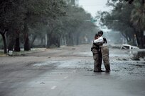 U.S. Air Force Pararescueman Staff Sgt. Lopaka Mounts, assigned to the 331st Air Expeditionary Group receives a hug from a resident during search and rescue operations after Hurricane Ike,  September 13, 2008.  