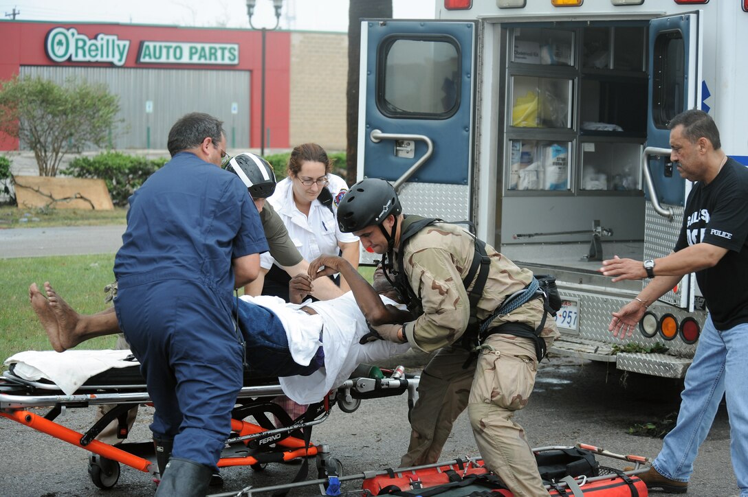 U.S. Air Force Staff Sgt. Lopaka Mounts, a Pararescueman assigned to the 331st Air Expeditionary Group, crossloads a patient to a litter during search and rescue operations in Galveston Texas after Hurricane Ike,  September 13, 2008.  