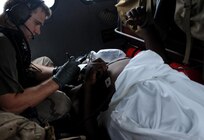U.S. Air Force Senior Airman Brandon Smith, a pararescueman assigned to the 331st Air Expeditionary Group, provides medical assistance to an injured resident during search and rescue operations in Galveston, Texas, Sept. 13, 2008, following the landfall of Hurricane Ike. 