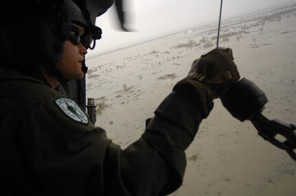 U.S. Air Force Staff Sgt. Will Nabakowski, an HH-60 Pave Hawk helicopter flight engineer assigned to the 331st Air Expeditionary Group, conducts search and rescue operations for stranded residents in Galveston, Texas, Sept. 13, 2008, following the landfall of Hurricane Ike. 