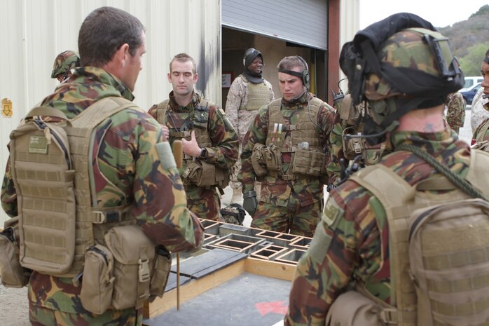 New Zealand Army soldiers study a terrain model at the Infantry Immersion Trainer here during Exercise Dawn Blitz 2013, June 13. The IIT gave the New Zealander's a taste of what they might encounter in future combat operations. Dawn Blitz 2013 is a scenario-driven exercise designed to test Navy and Marine Corps forces at the Marine Expeditionary Brigade (MEB) and Expeditionary Strike Group (ESG) level, while promoting military-to-military cooperation and interoperability with partnered nations.