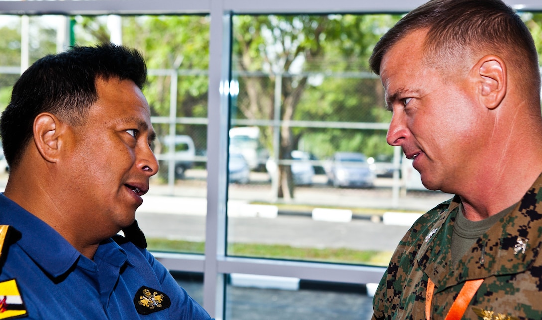 Royal Brunei Armed Forces First Adm. Dato Seri Pahlawan Haji Abdul Halim bin Haji Mohd Hanifah, left, speaks with U.S. Marine Col. Douglas Pasnik, during the opening ceremony to the Association of Southeast Asian Nations Humanitarian Assistance/Disaster Relief and Military Medicine Exercise (AHMX) at the Multinational Coordination Centre in Muara, Brunei Darussalam, June 17. AHMX is a multilateral exercise that provides a forum for regional partner nations to address shared security challenges, strengthen defense cooperation, enhance interoperability and promote stability in the region. Halim is the commander of the Royal Brunei Navy. Pasnik is the director of regional operations for U.S. Marine Corps Forces, Pacific.