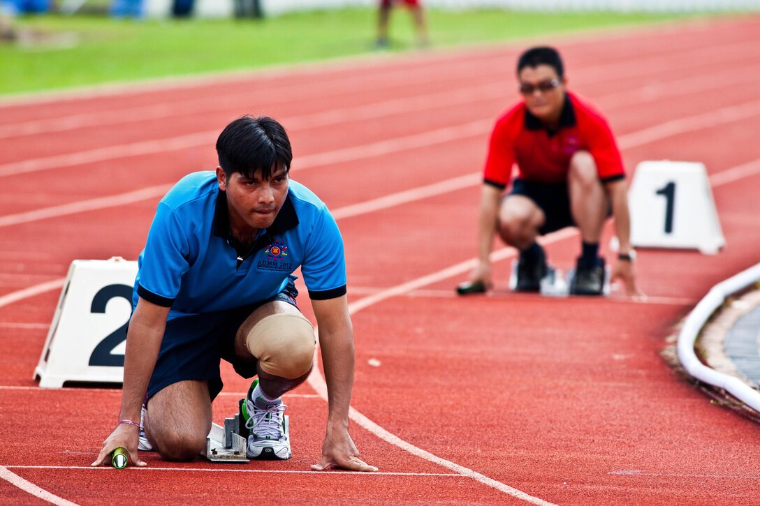 Indian Army Maj. Vijay Bohra, left, prepares to take off in a relay race during a sports field meet at Berakas Army Garrison Camp, Brunei Darussalam, June 14. The competition took place as part of the Association of Southeast Asian Nations Defence Ministers Meeting (ADMM) - Plus ASEAN Humanitarian Assistance/Disaster Relief and Military Medicine Exercise (AHMX). During the field meet, nations competed in a four-team, 400-meter relay event and a tug-of-war competition. Bohra is a physician participating in the exercise.