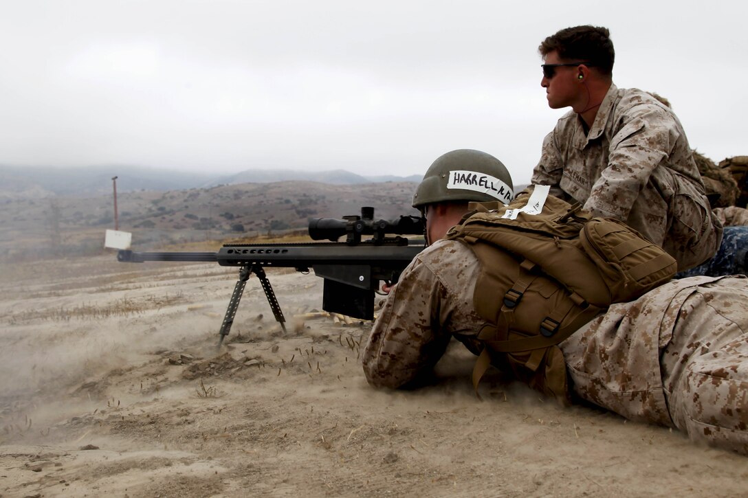 Midshipman 3rd Class Ronald Harrell fires a .50-caliber long-range sniper rifle with help from scout sniper Lance Cpl. John Lemar during Marine Week of Career Orientation and Training for Midshipmen-West 2013 here June 12. Future officers from across the U.S. participated in the four-weeks of training designed to introduce them to career opportunities.