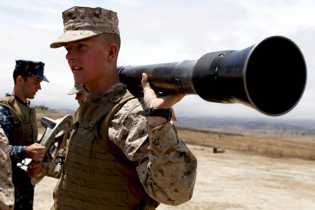 Midshipman 3rd Class Ty Gunnlaugsson tests the weight of an 81-millimeter mortar cannon barrel during Marine Week of Career Orientation and Training for Midshipmen-West 2013 here June 12. Future officers from across the U.S. participated in the four-weeks of training designed to introduce them to career opportunities.