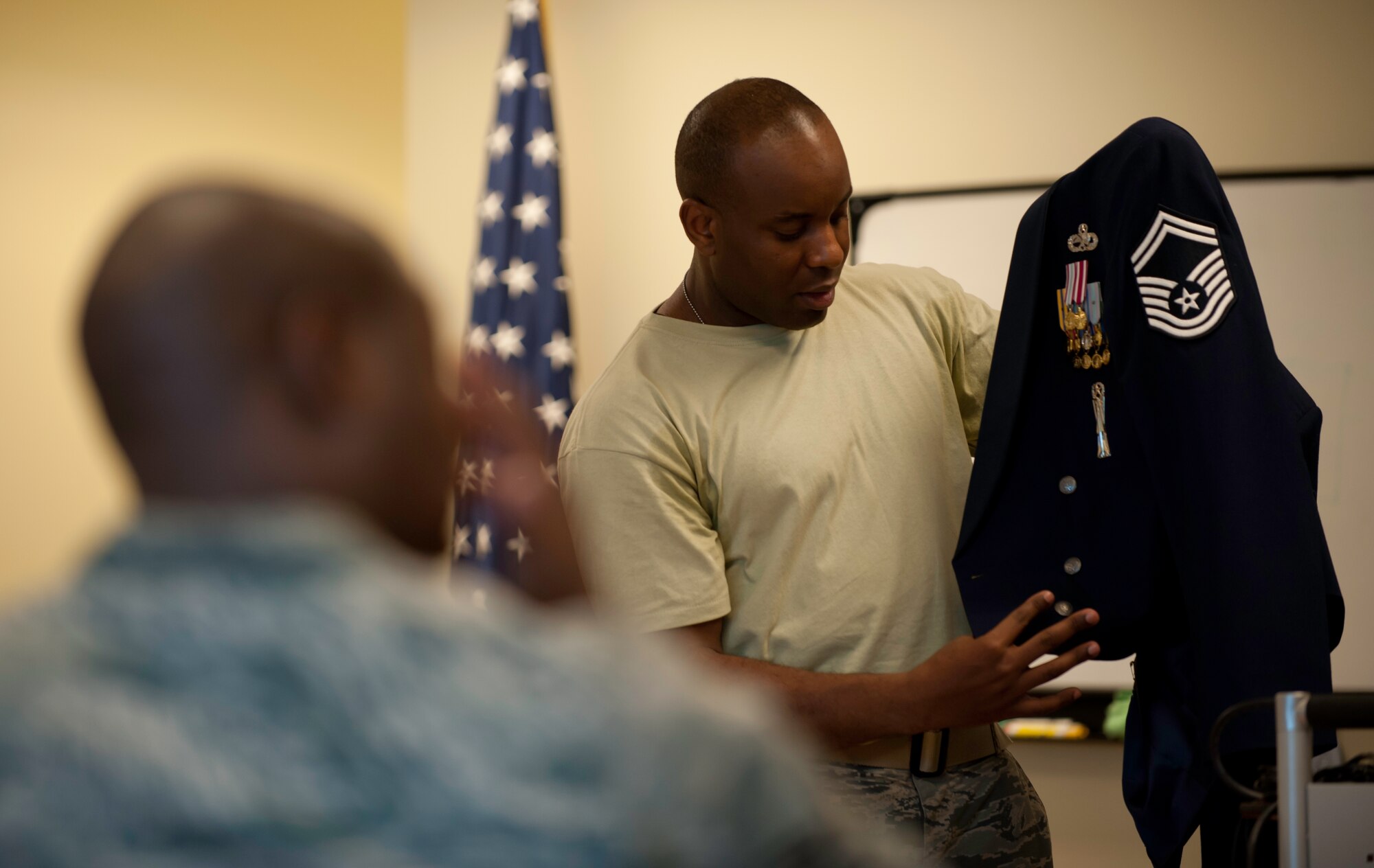 Senior Master Sgt. Steve West, 8th Maintenance Squadron, displays his uniform to participants in the Sharp Image Course at Kunsan Air Base, Republic of Korea, June 14, 2013. West, a former Air Force Honor Guard member, taught the class to give Airmen tips and tricks on maintaining their uniform. (U.S. Air Force photo by Senior Airman Armando A. Schwier-Morales)