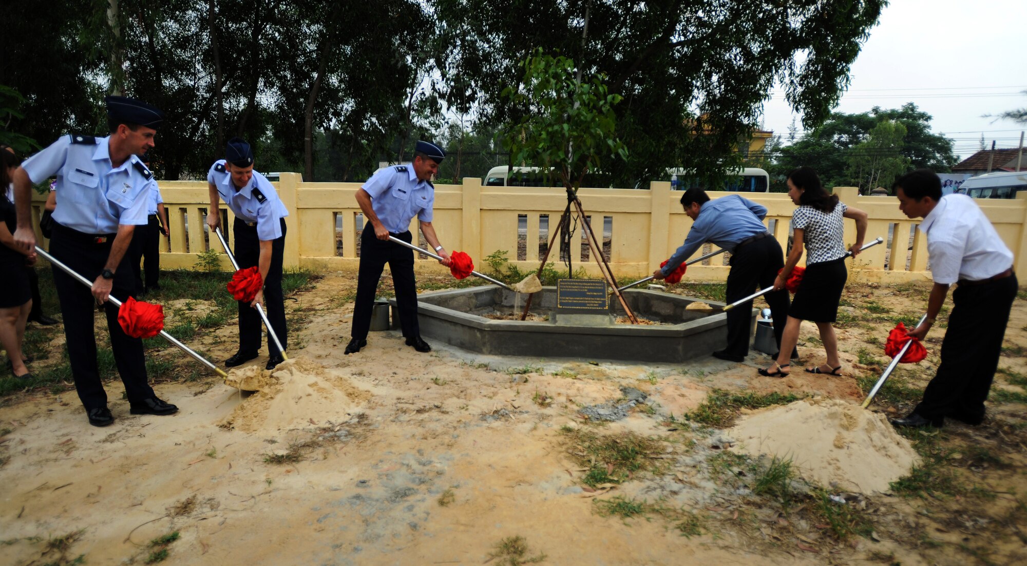 Pacific Air Forces leadership (left) and community leaders of the Quang Binh Province (right) plant a tree together as a symbol of friendship between the U.S. and Vietnam after wrapping up Operation Pacific Angel 13-3 in Dong Hoi, Quang Binh Province, Vietnam, June 17, 2013. Operation PACANGEL is a joint and combined humanitarian assistance exercise held in various countries several times a year and includes medical, dental, optometry, engineering programs and a variety of subject-matter expert exchanges. (U.S. Air Force photo by Staff Sgt. Sara Csurilla)


