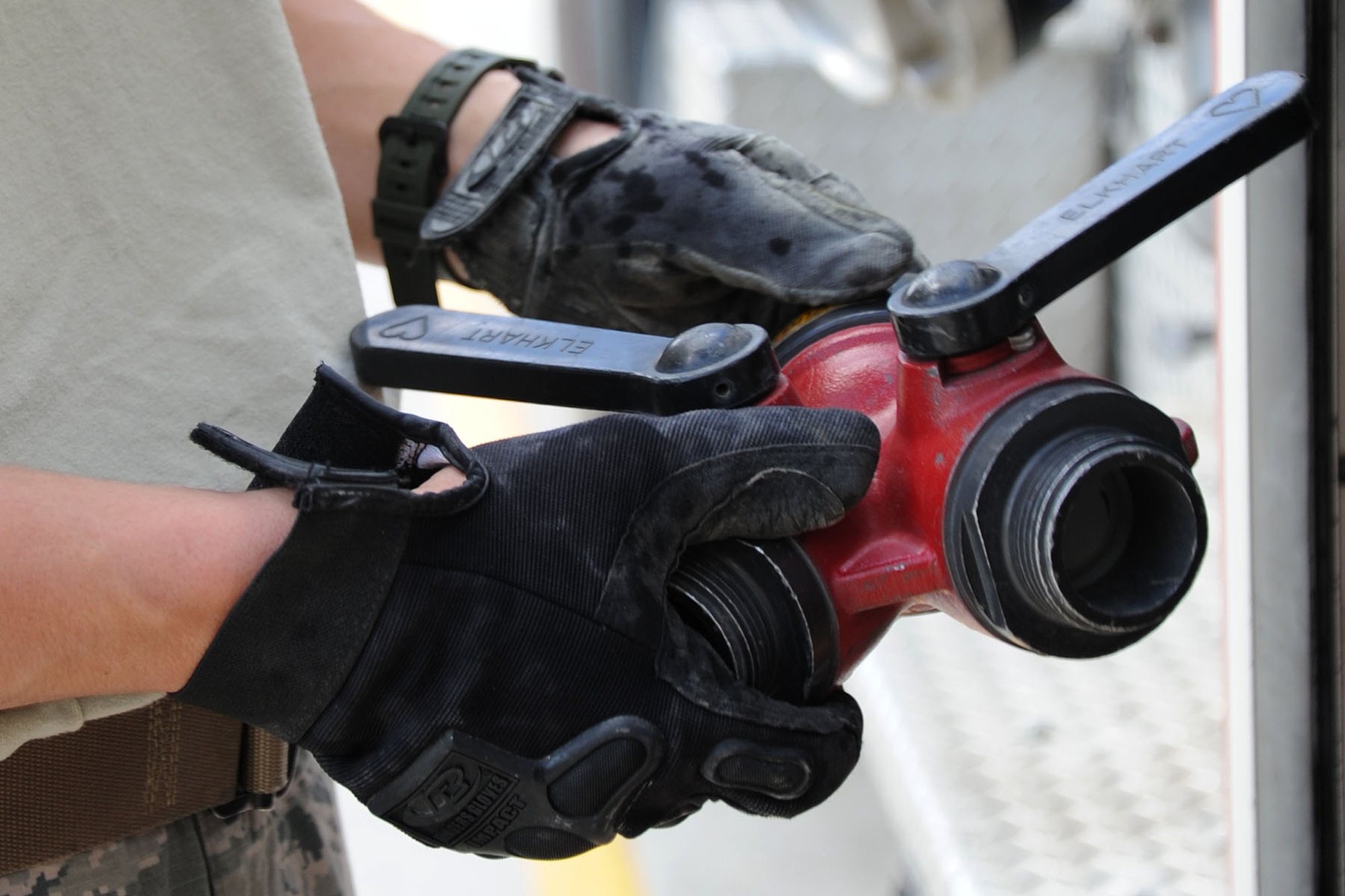 Senior Airman Alberto Garcia-Vidal, 92nd Civil Engineer Squadron firefighter, examines a gated wye valve during an operational inspection at Fairchild Air Force Base, Wash., June 12, 2013. The gated wye valve is used to enable the crews to divide a single hose line into two separate attack lines. (U.S. Air Force photo by Airman 1st Class Janelle Patiño/Released)