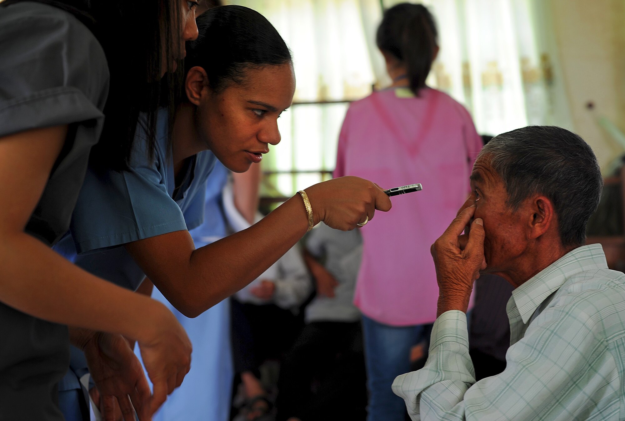 Staff Sgt. Sharde Owens, optometry technician from the 45th Medical Group out of Patrick Air Force Base, Fla., examines a patient's eye as part of Health Service Outreach Program during Operation Pacific Angel 13-3 in Dong Hoi, Quang Binh Province, Vietnam, June 15, 2013. Optometry was one of the various medical services offered as part of the Health Services Outreach program during the reoccurring humanitarian mission. Operation PACANGEL is a joint and combined humanitarian assistance exercise held in various countries several times a year and includes medical, dental, optometry, engineering programs and a variety of subject-matter expert exchanges. (U.S. Air Force photo by Staff Sgt. Sara Csurilla)

