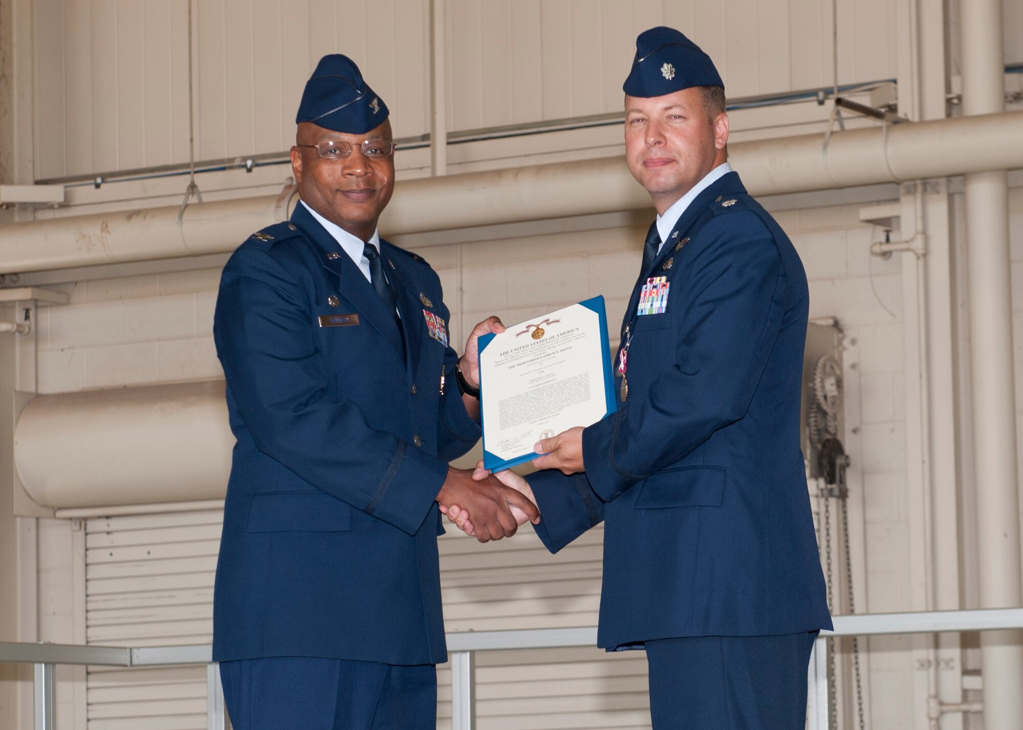 Lieutenant Col.  Anthony Nance, 49th Aircraft Maintenance Squadron outgoing commander, receives a Meritorious Service Medal, during a change of command ceremony at Holloman Air Force Base, N.M., June 14. . As the commander, Nance was responsible for the morale, welfare, training and discipline of more than 300 personnel. His squadron maintained 24 combat ready F-22 raptors in support of the 7th Fighter Squadron’s taskings. (U.S. Air Force photo by Airman 1st Class Daniel E. Liddicoet/Released)