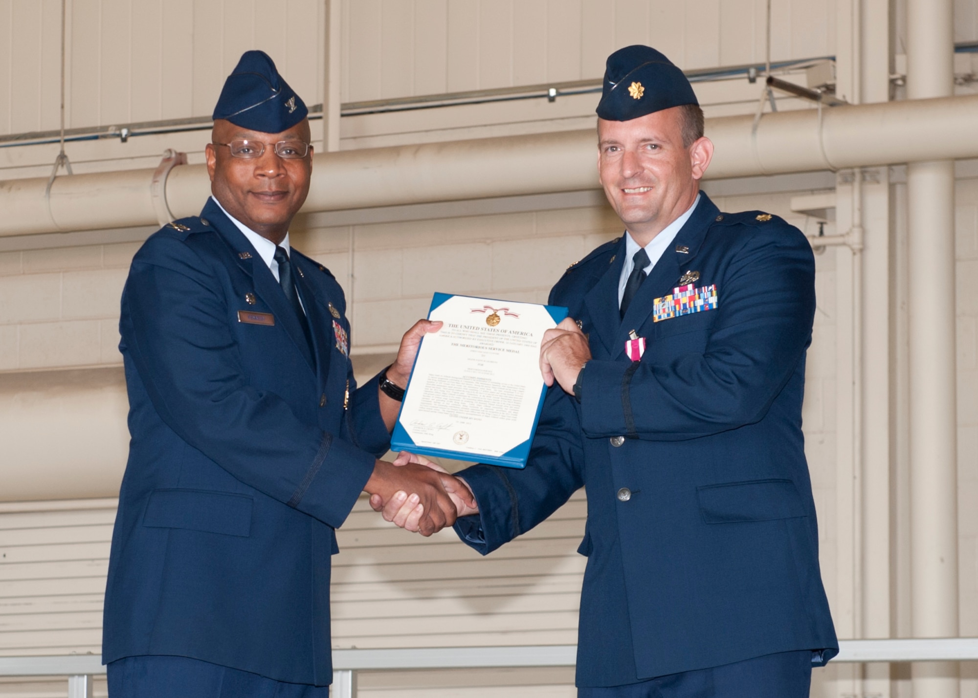 Major Justin Gilbreth, 49th Aircraft Maintenance Squadron incoming commander, receives a Meritorious Service Medal during a change of command ceremony at Holloman Air Force Base, N.M., June 14. Gilbreth recently served as the maintenance operations officer with the 849th Aircraft Maintenance Squadron. (U.S. Air Force photo by Airman 1st Class Daniel E. Liddicoet/Released)
