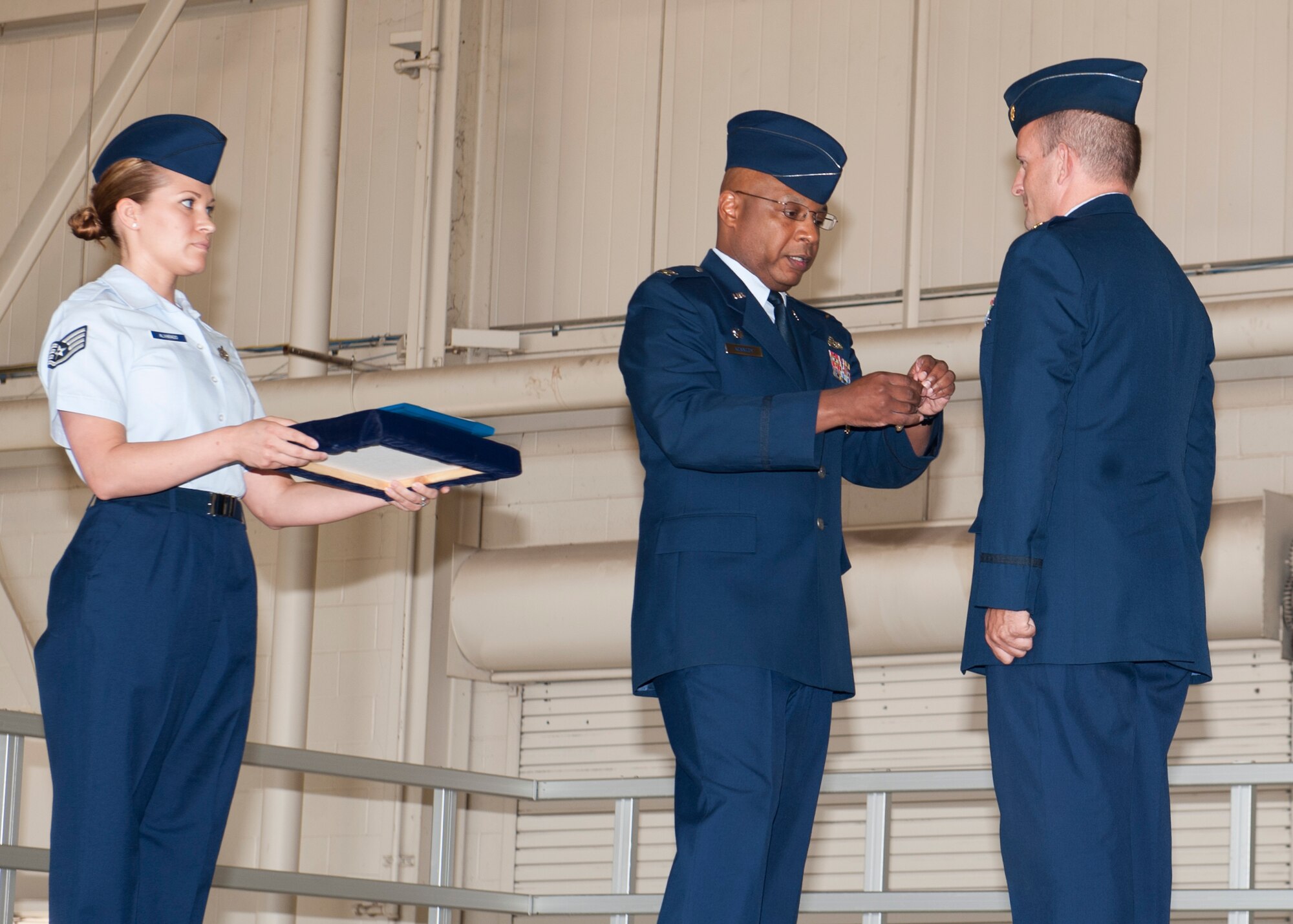 Colonel Andre Kennedy, 49th Maintenance Group commander, pins a Meritorious Service Medal on Maj. Justin Gilbreth, 49th Aircraft Maintenance Squadron incoming commander, during a change of command ceremony at Holloman Air Force Base, N.M., June 14. Gilbreth recently served as the maintenance operations officer with the 849th Aircraft Maintenance Squadron. (U.S. Air Force photo by Airman 1st Class Daniel E. Liddicoet/Released)