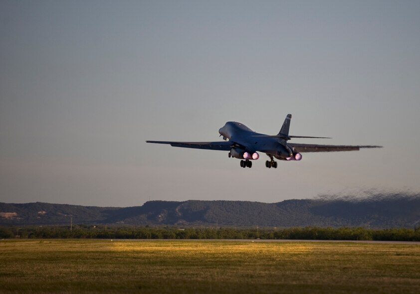 A B-1 Bomber takes off from the flightline as part of a surge operation June 12, 2013, at Dyess Air Force Base, Texas. The surge operation allowed aircrew members and maintainers to practice as if they were operating in a deployed environment, with the goal to launch as many sorties as possible within the shortest amount of time. (U.S. Air Force photo by Airman Autumn Velez/ Released)