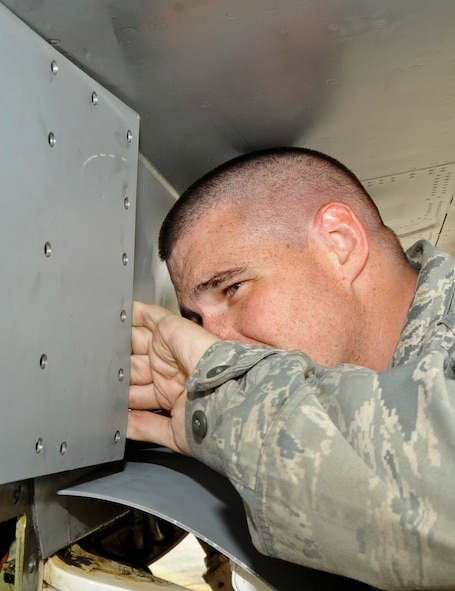 U.S. Air Force Staff Sgt. Cunningham, 35th Aircraft Maintenance Squadron electrical and environmental specialist, pulls back an outer-layer panel of a F-16 Fighting Falcon during an operational readiness exercise at Misawa Air Base, Japan, June 17, 2013. The purpose of the ORE is to test the wing on their readiness capabilities and primary duty knowledge. Phase II, focused on Airmen completing their jobs as if operating in  a combat zone. (U.S. Air Force photo by Airman 1st Class Kenna Jackson)