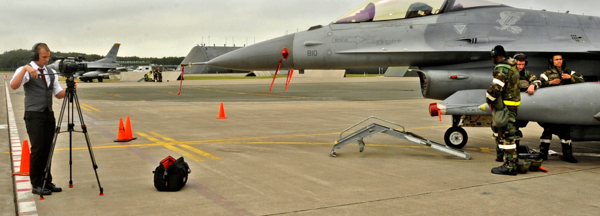 U.S. Air Force Airman 1st Class Jake Lombardi, 35th Fighter Wing Public Affairs broadcaster, plays the part of embedded media as he documents several maintainers working on a F-16 Fighting Falcon during an operational readiness exercise at Misawa Air Base, Japan, June 17, 2013. The simulation gave 35 FW Airmen the opportunity to retrain in media escorting rules and interview techniques. (U.S. Air Force photo by Airman 1st Class Kenna Jackson)