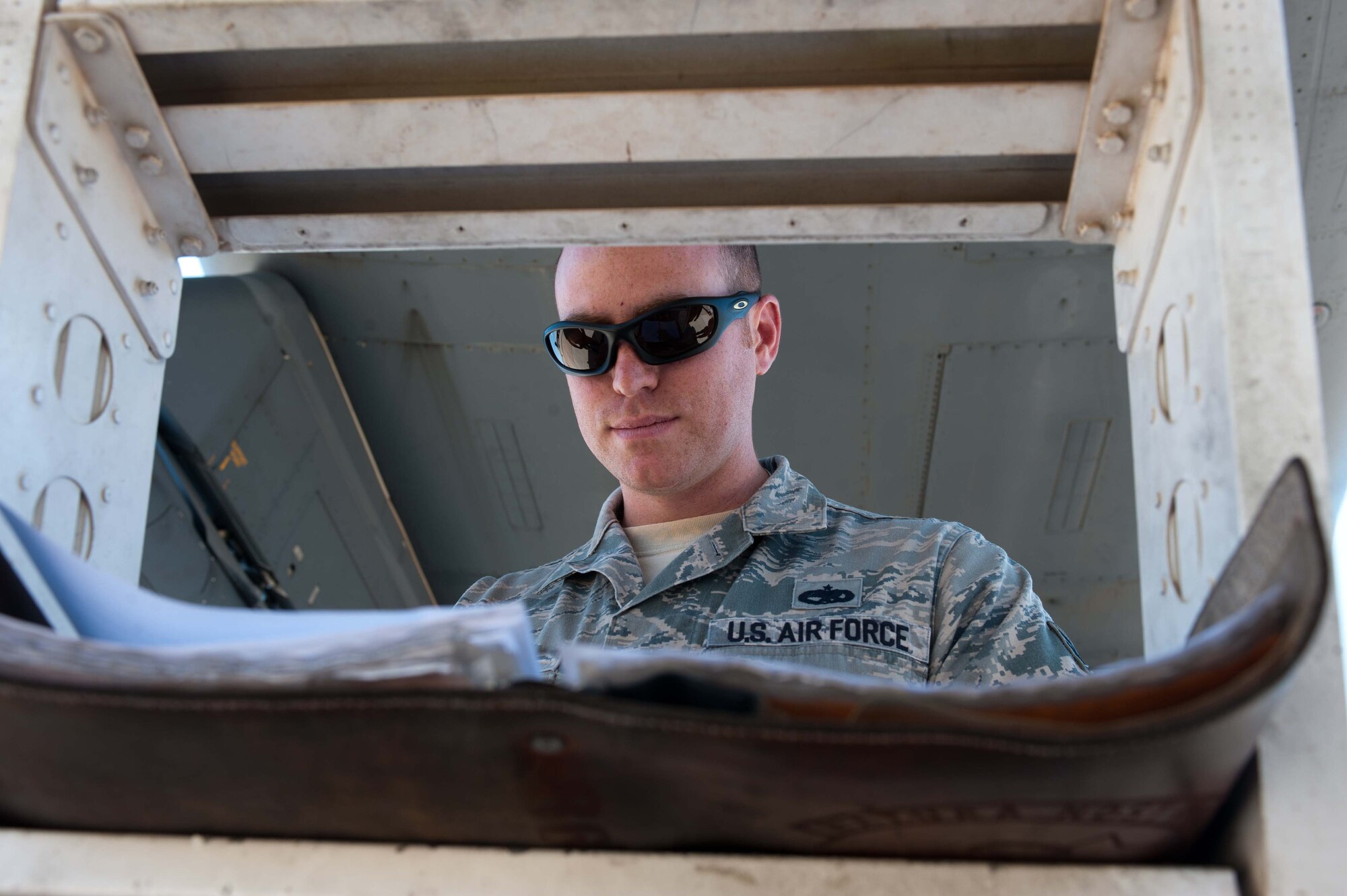 U.S. Air Force Staff Sgt. Neal Buzek, 7th Aircraft Maintenance Squadron, ensures all maintenance technical orders have been completed prior to finishing the pre-flight checklist on a B-1 Bomber June 11, 2013, at Dyess Air Force Base, Texas. From June 10-13, the 9th Bomb Squadron (BS) performed a sortie surge, attempting to fly 74 sorties in four days completing 58. The surge was performed to ensure all aircrews and maintainers of the 9th BS are operational wartime qualified for their upcoming deployment. (U.S. Air Force photo by Airman 1st Class Kylsee Wisseman/Released)