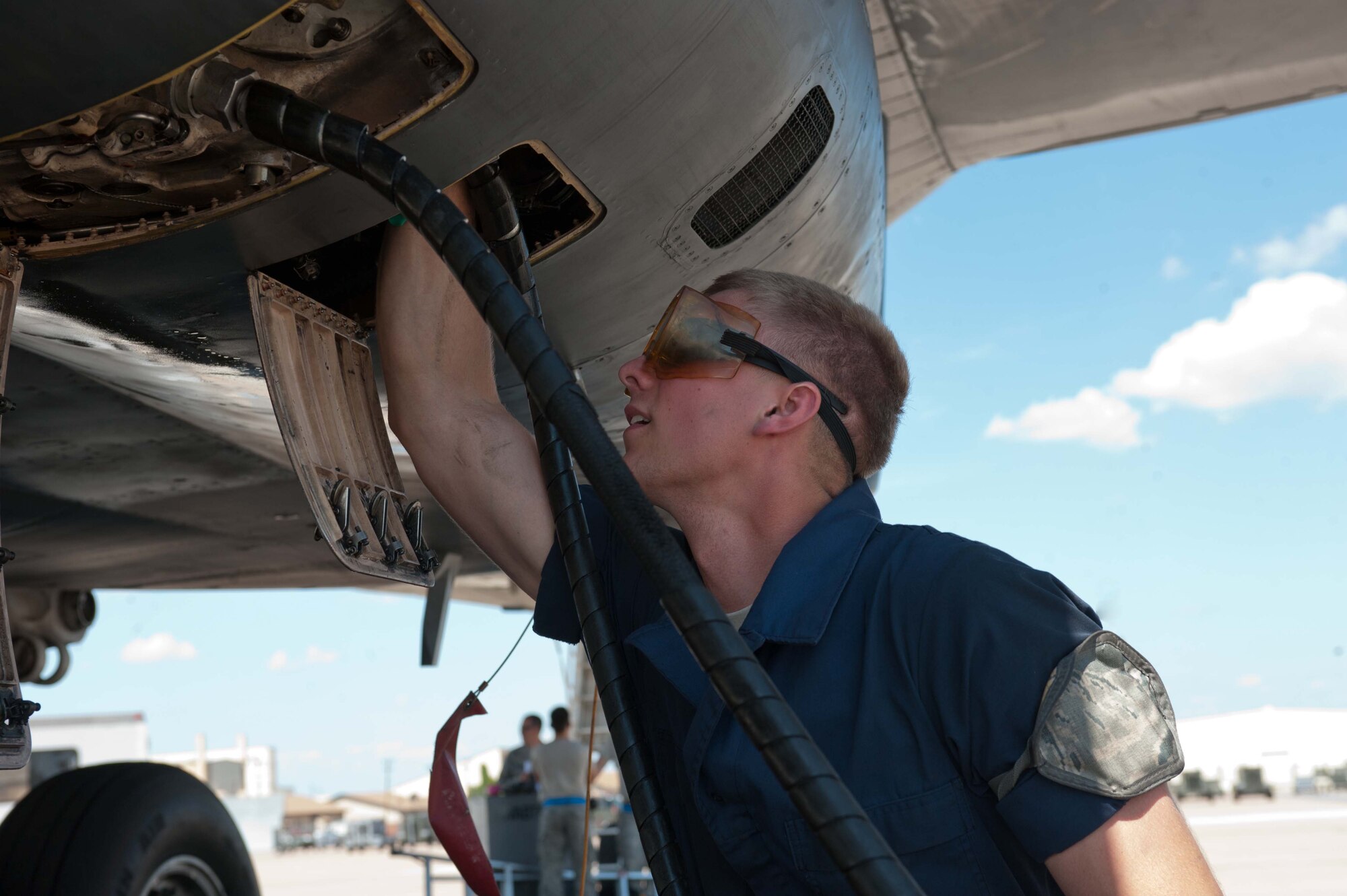 U.S. Air Force Airman 1st Class Todd Van Zandt, 7th Aircraft Maintenance Squadron, services a B-1 Bomber June 11, 2013, at Dyess Air Force Base, Texas.  From June 10-13, the 9th Bomb Squadron (BS) performed a sortie surge, attempting to fly 74 sorties in four days completing 58. The surge was performed to ensure all aircrews and maintainers of the 9th BS are operational wartime qualified for their upcoming deployment.  (U.S. Air Force photo by Airman 1st Class Kylsee Wisseman/Released)