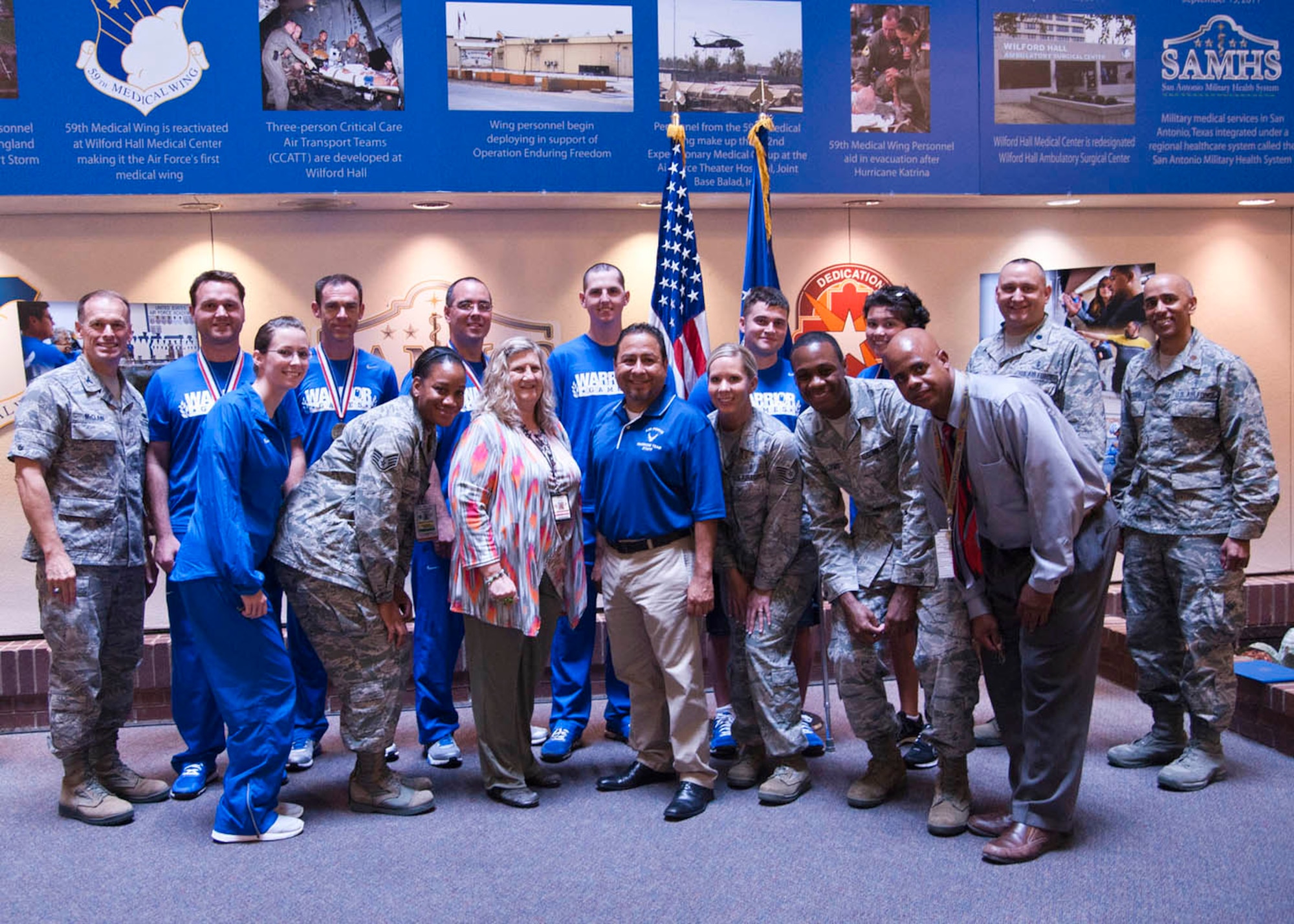 59th Medical Wing Vice Commander Col. James McClain poses with members of the 59th Medical Wing Patient Squadron and the Wounded Warrior Project June 12 at the Wilford Hall Ambulatory Surgical Center. Wounded Warriors from the Patient Squadron were recognized for winning six of the Air Force's 30 medals at the 2013 Wounded Warrior Games. (U.S. Air Force photo/Senior Airman Courtney Moses)