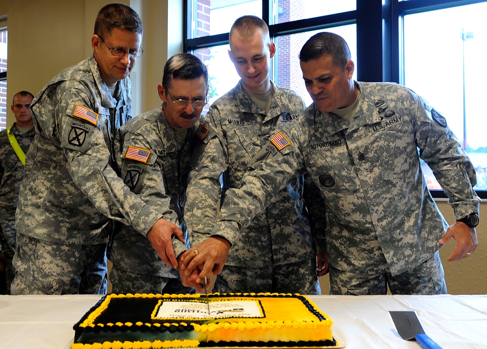 (From left) U.S. Army Col. Albert Stiller, 128th Aviation Brigade deputy commanding officer; Sgt. 1st Class Forrest Boatman, 1st Battalion, 210th Aviation Regiment instructor writer; Pfc. Jacob Morris, 1st BN, 222nd AVN Regiment Alpha Company; and Sgt. Maj. Estevan Sotorosado, 1st BN, 222nd AVN Regiment command sergeant major, cut the U.S. Army birthday cake at the Warrior Café at Fort Eustis, Va., June 14, 2013. The cake cutting celebrated the Army’s 238th birthday.  Boatman, the brigade’s oldest member, and Morris, the youngest member, were chosen to cut the cake as a part of Army tradition. (U.S. Air Force photo by Staff Sgt. Dana Hill/Released)