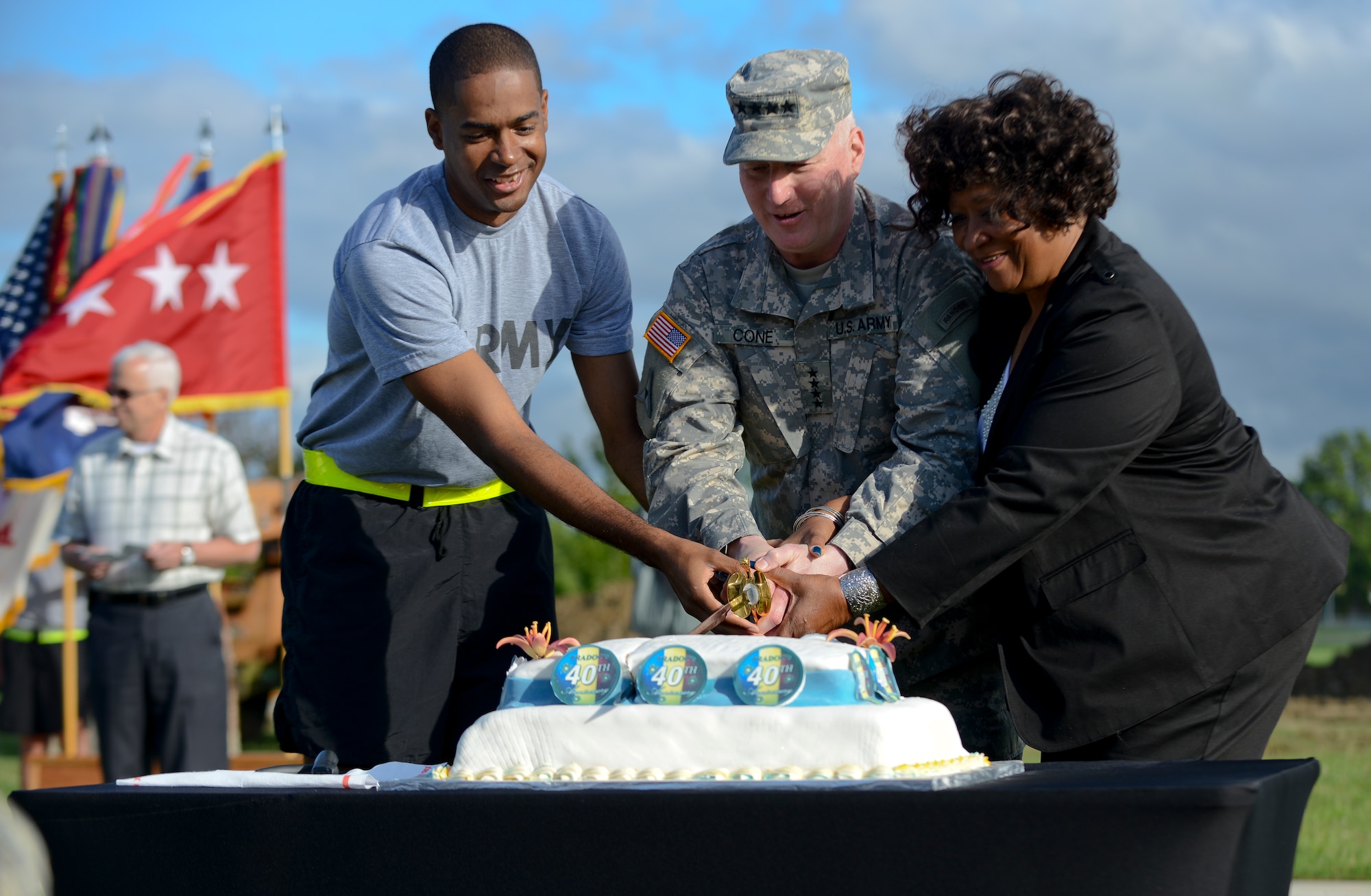U.S. Army Gen. Robert Cone, Training and Doctrine Command commander, cuts the Army and TRADOC birthday cake with Fort Eustis's newest Soldier, Spc. James Miller, TRADOC band member, and longest-serving civilian, Nelly Herbin, TRADOC management analyst, June 14, 2013 at Fort Eustis, Va. A saber is traditionally used to cut the cake, harkening back to the beginning of the service when horse cavalry utilized sabers instead of bayonets in close combat. (U.S. Air Force photo by Airman 1st Class Austin Harvill/Released)