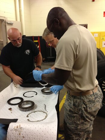 Col. Darren Hartford, 437th Airlift Wing commander, and Col. Dennis Dabney, 437th Maintenance Group commander, visited the 437th Maintenance Squadron Wheel and Tire shop, June 13, 2013, at Joint Base Charleston – Air Base, S.C. Hartford and Dabney pitched in to help perform maintenance on C-17 wheel assemblies. (U.S. Air Force photo/ Master Sgt. Robert Wilkinson)