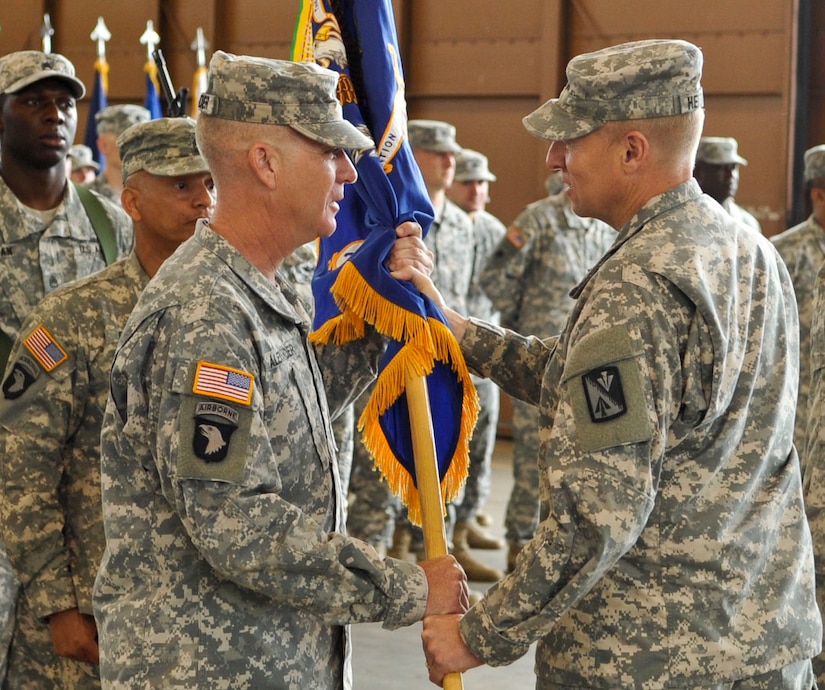 U.S. Army Lt. Col. Richard Alexander, 210th Aviation Regiment commander, receives the guidon from Col. Dean Heitkamp, right, 128th Aviation Brigade commander, during the unit’s change of command ceremony at Fort Eustis, Va., June 17, 2013. Alexander assumed command of the unit from Lt. Col. Vernon Miles. (U.S. Air Force photo by Staff Sgt. Wesley Farnsworth / Released)