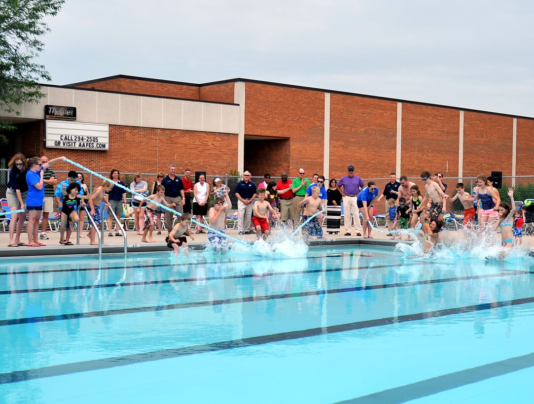 Children from Team Offutt jump through a ceremonial ribbon marking the
re-opening of the Capehart Pool June 15. Initially closed in light of
budgetary constraints due to the ongoing sequestration, the pool was given
new life thanks to a donation to the base's Morale, Welfare and Recreation
Fund by the Nebraska Military Support Coalition and the Strategic Command
Consultation Committee a few weeks ago. (Air Force photo by Jeff Gates/Released)
