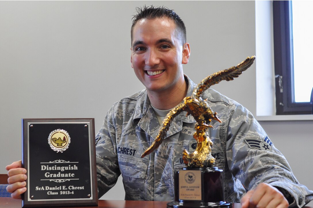 YOUNGSTOWN AIR RESERVE STATION, Ohio – Senior Airman Daniel Chrest, 910th Force Support Squadron (FSS) services journeyman, shows two of the awards he received at Airman Leadership School: the Distinguished Graduate Award and the John L. Levitow Award.  (U.S. Air Force photo/Staff Sgt. Megan Tomkins)