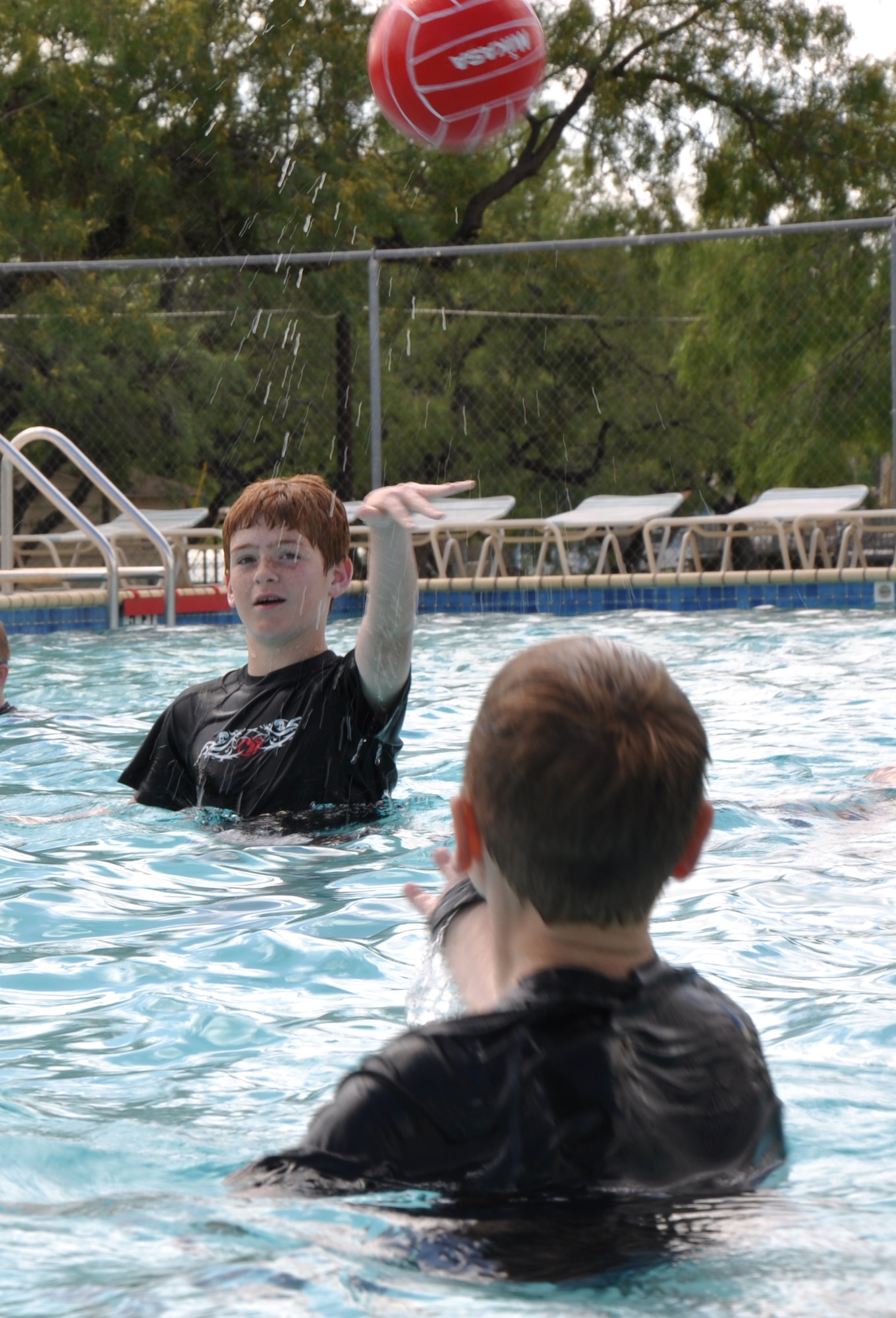 GOODFELLOW AIR FORCE BASE, Texas – Owen Sinner, Sideline Sports youth participant, passes a ball to a fellow teammate during a drill for the water polo day of Sideline Sports at the Goodfellow Recreation Camp pool, June 12. Owen and other participants took part in non-traditional sports as part of the Sideline Sports program. (U.S. Air Force photo/ Airman 1st Class Joshua Edwards)