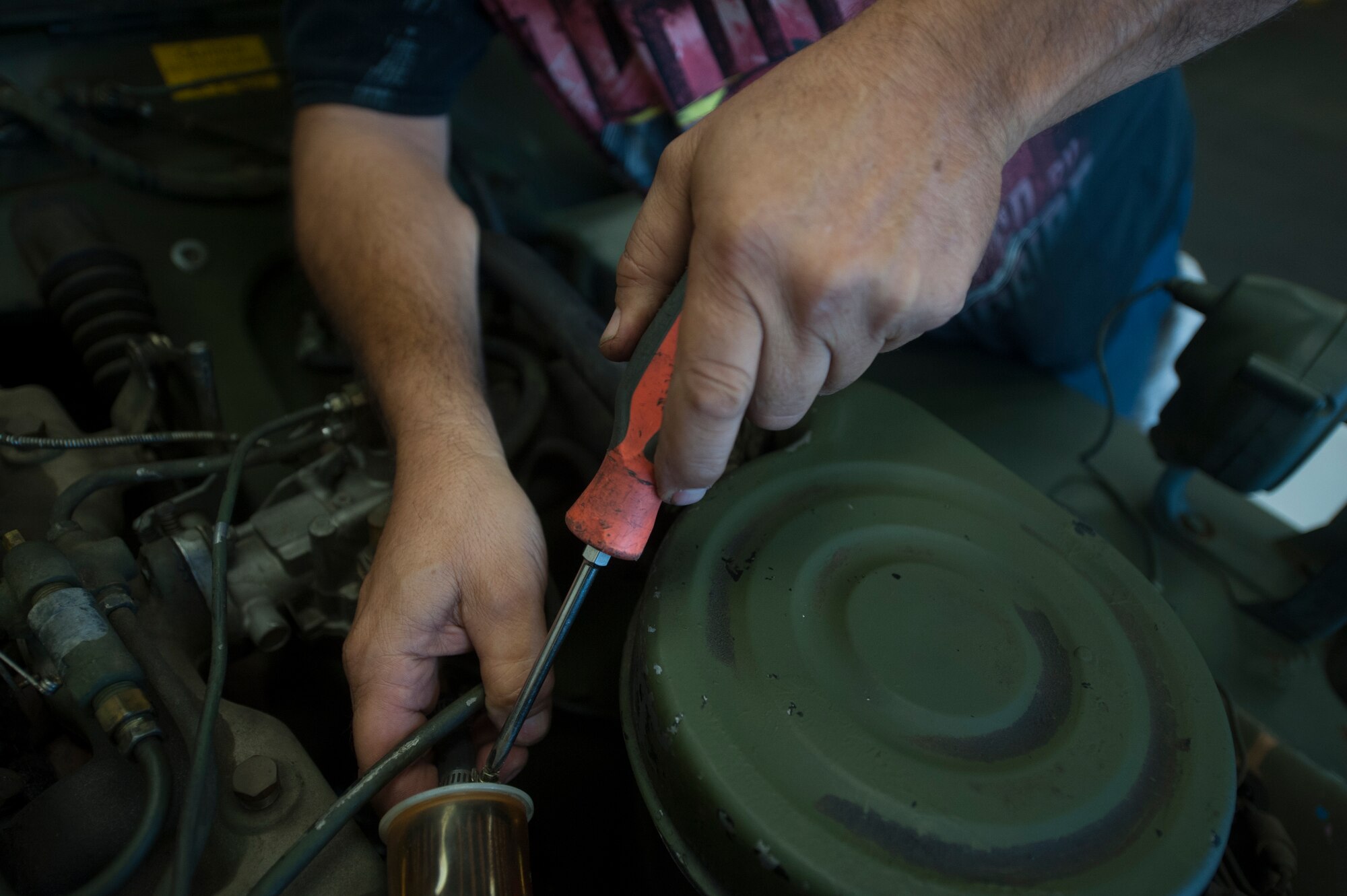 John Zakar, 23d Logistics Readiness Squadron service writer, grips a screwdriver while working on an M151 jeep ambulance –era jeep ambulance May 31, 2013 at Moody Air Force Base, Ga. Zakar has made it his mission to keep the vehicle’s history alive. (U.S. Air Force photo by Airman 1st Class Sandra Marrero/released)  

