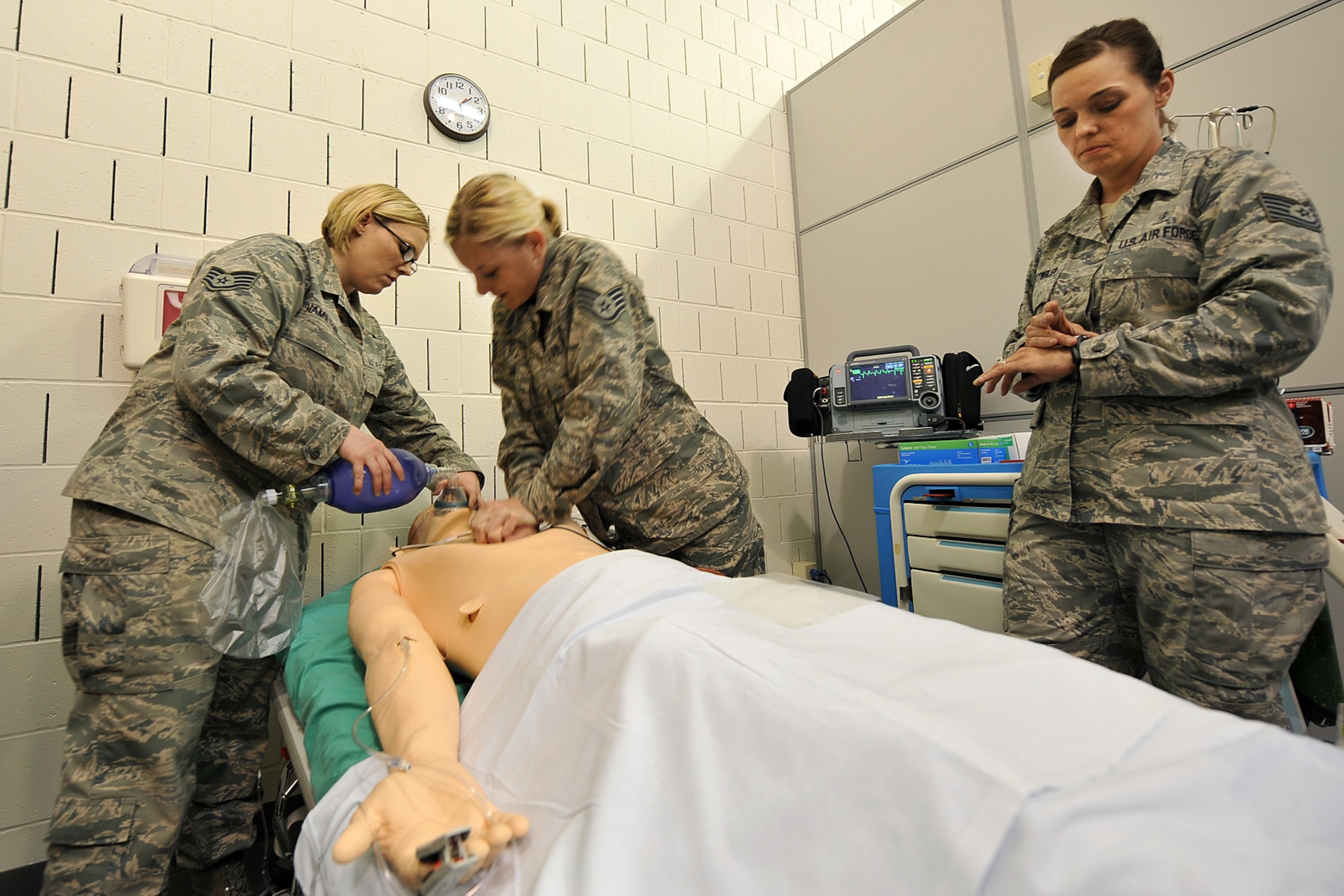 U.S. Air Force Staff Sgt. Kristeen Hamilton, 55th Medical Operations Squadron, squeezes the Ambu-bag resuscitator while U.S. Air Force Staff Sgt. Kelly Doran, 55th Medical Operations Squadron, applies cardiopulmonary resuscitation on the SimMan 3G manikin during a demonstration at the Ehrling Berquist Clinic on Offutt Air Force Base, Neb., June 7. The new simulation laboratory will allow medical group staff and others to gain and maintain clinical level experience in a hospital setting. (Air Force photo by Charles Haymond /Released)