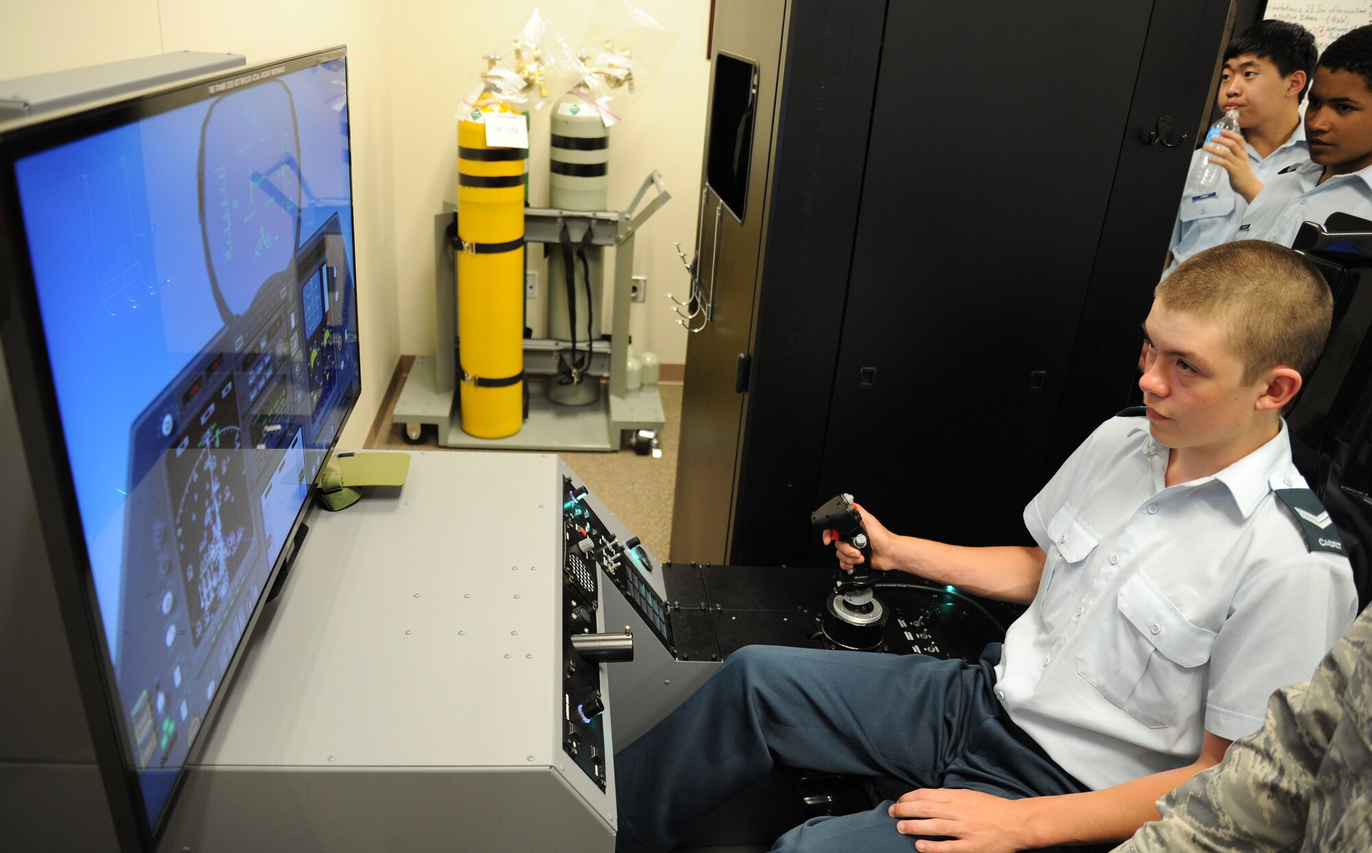 Corporal Curtis Sarton, a Royal Canadian Air Cadet, flies a simulated F-22 mission on the Hypoxia Familiarization Trainer during a base tour at Fairchild Air Force Base, Wash., June 7, 2013. Fairchild conducted the tour which consisted of 21 cadets from British Columbia, Canada. (U.S. Air Force photo by Airman 1st Class Janelle Patiño/Released)