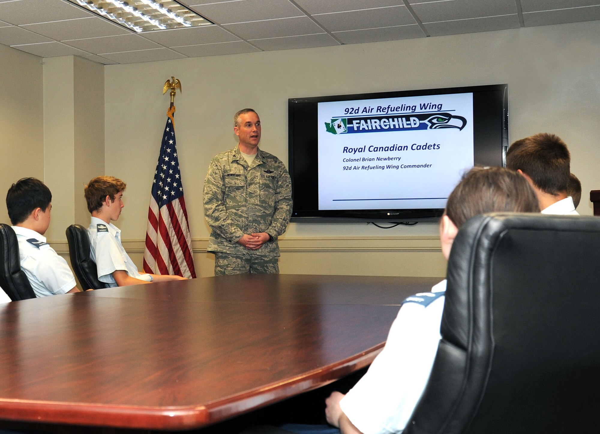 Col. Brian Newberry, 92nd Air Refueling Wing commander, speaks with a group of Royal Canadian Air Cadets, a Canadian national youth program for people ages 12 to 18, during a tour at Fairchild Air Force Base, Wash., June 7, 2013. Newberry welcomed and thanked the cadets for taking the time to visit. (U.S. Air Force photo by Airman 1st Class Janelle Patiño/Released) 